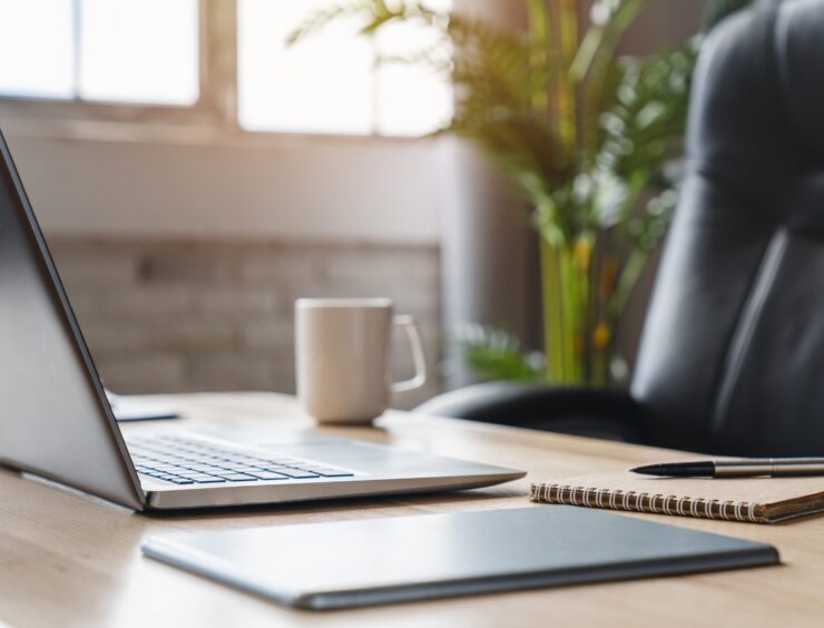 Image,Of,An,Office,Employee's,Desk,With,Laptop,On,Table Image,Of,An,Office,Employee's,Desk,With,Laptop,On,Table